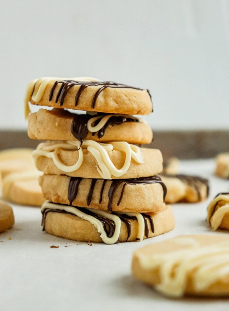 stack of shortbread cookies drizzled with white and dark chocolate