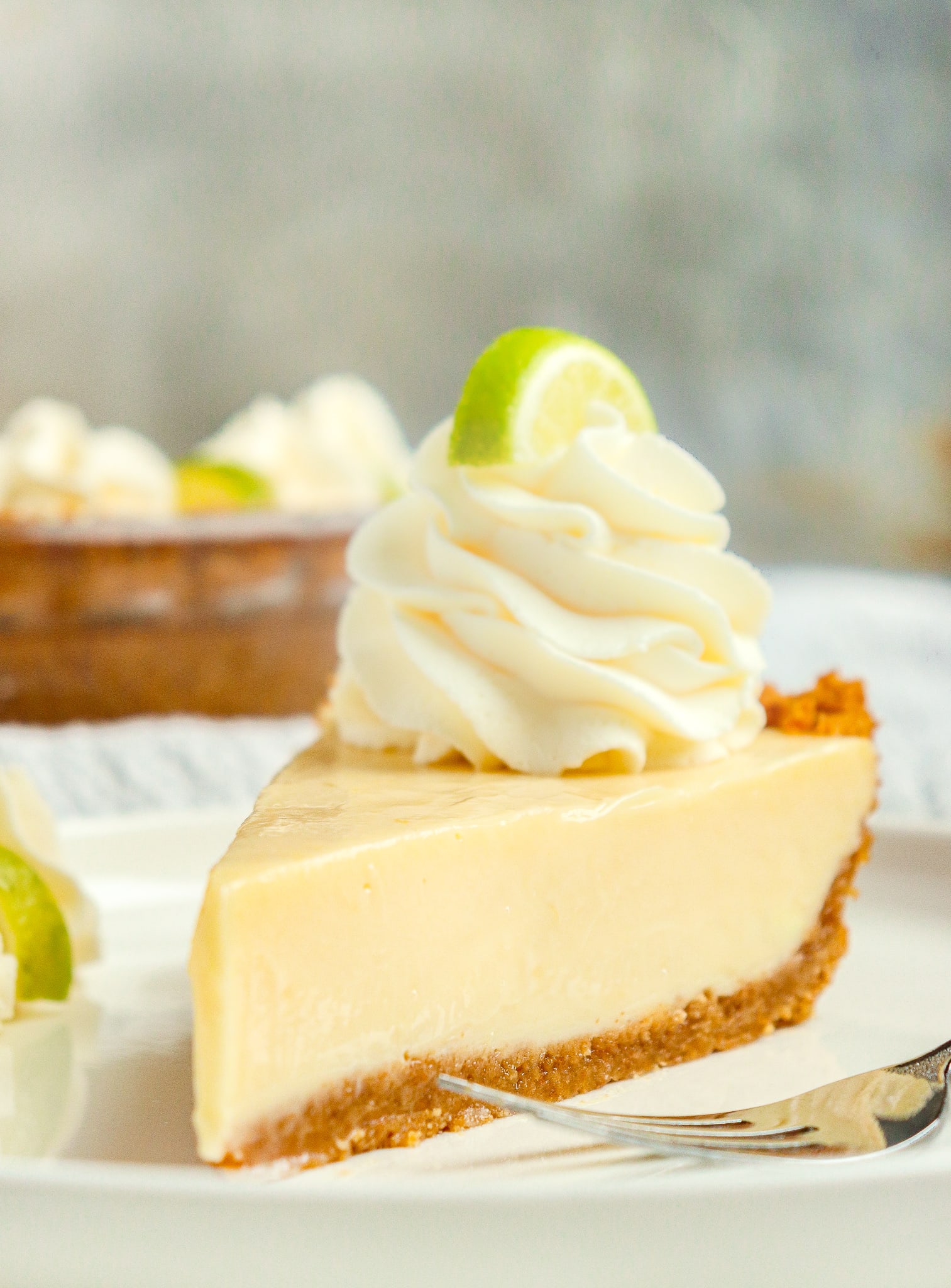 slice of key lime pie with whipped cream and slice of lime on top