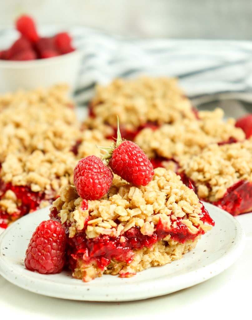 berry oatmeal bars topped with raspberries