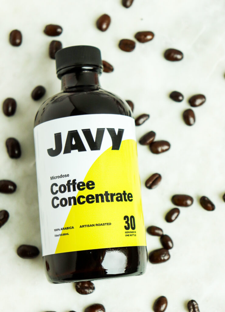 bottle of Javy Coffee Concentrate with coffee beans