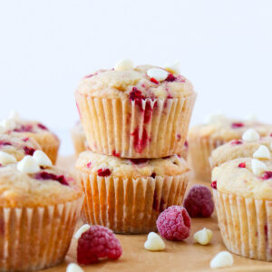 Two raspberry white chocolate muffins stacked.