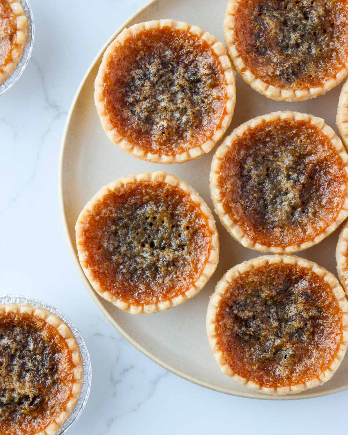 Butter tarts on a plate.