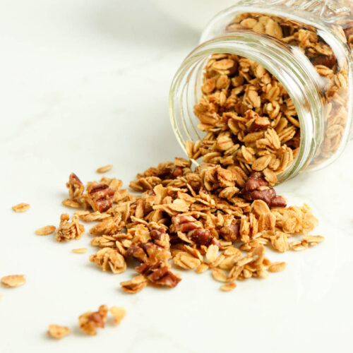 Granola pouring out of a jar.