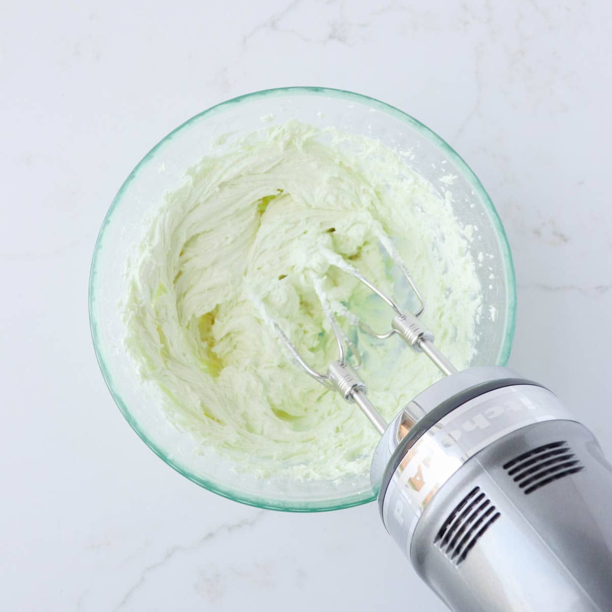 Green mint frosting in a bowl.