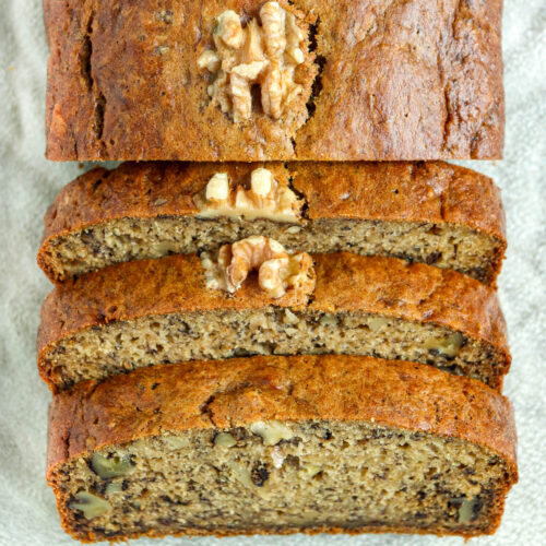 Slices of banana bread topped with walnuts.