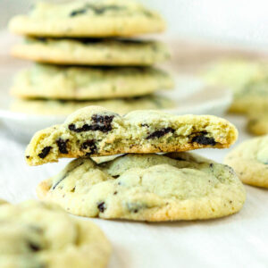 Stacked pistachio cookies with chunks of Oreos inside.