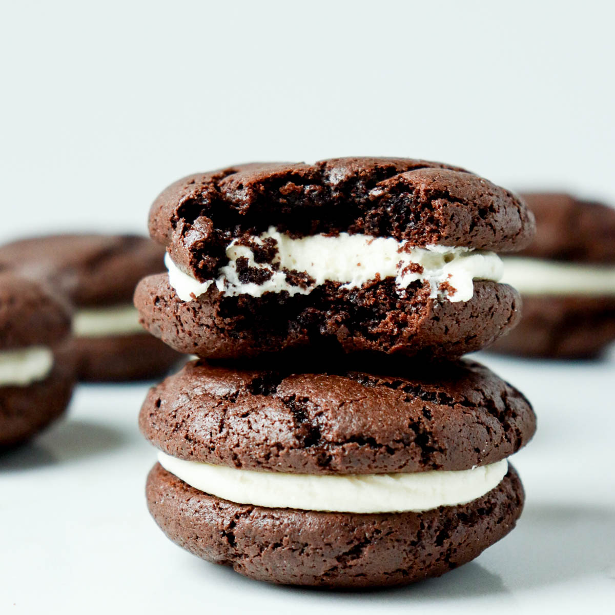 Stacked chocolate sandwich cookies with cream cheese frosting filling.