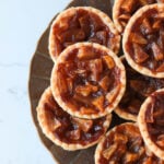 Apple pie tarts on a brown plate.
