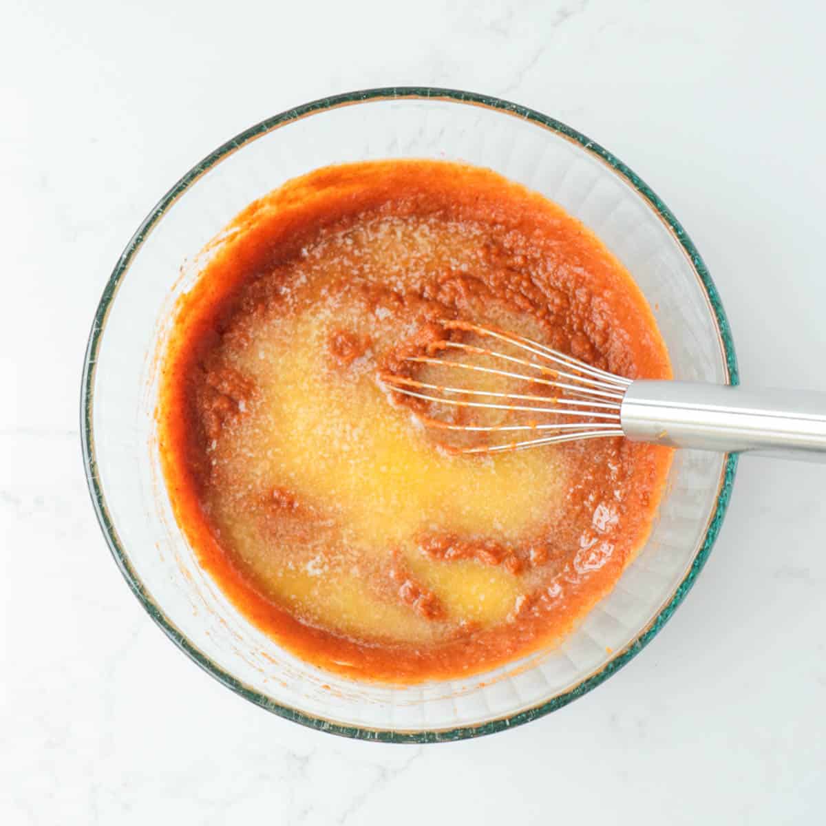 Melted butter added to combined pumpkin filling ingredients.