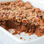 Pecan pumpkin crisp in a white baking pan.
