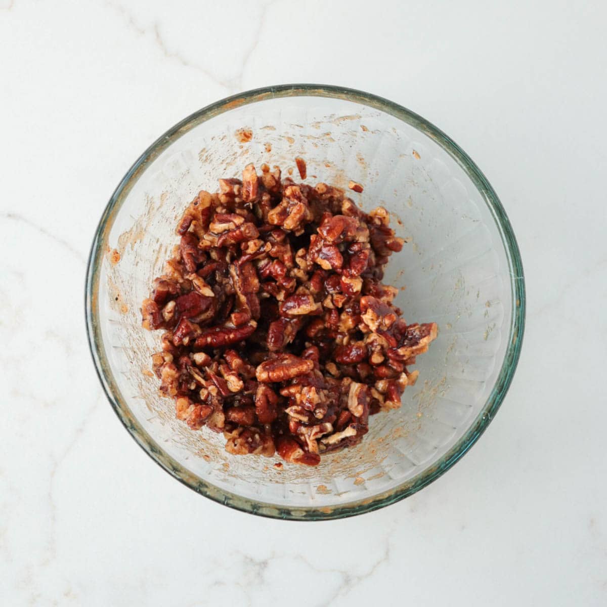 Brown sugar and pecan mixture combined in a glass bowl.