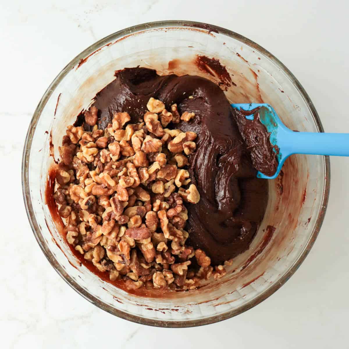 Chopped walnuts added to fudge mixture.