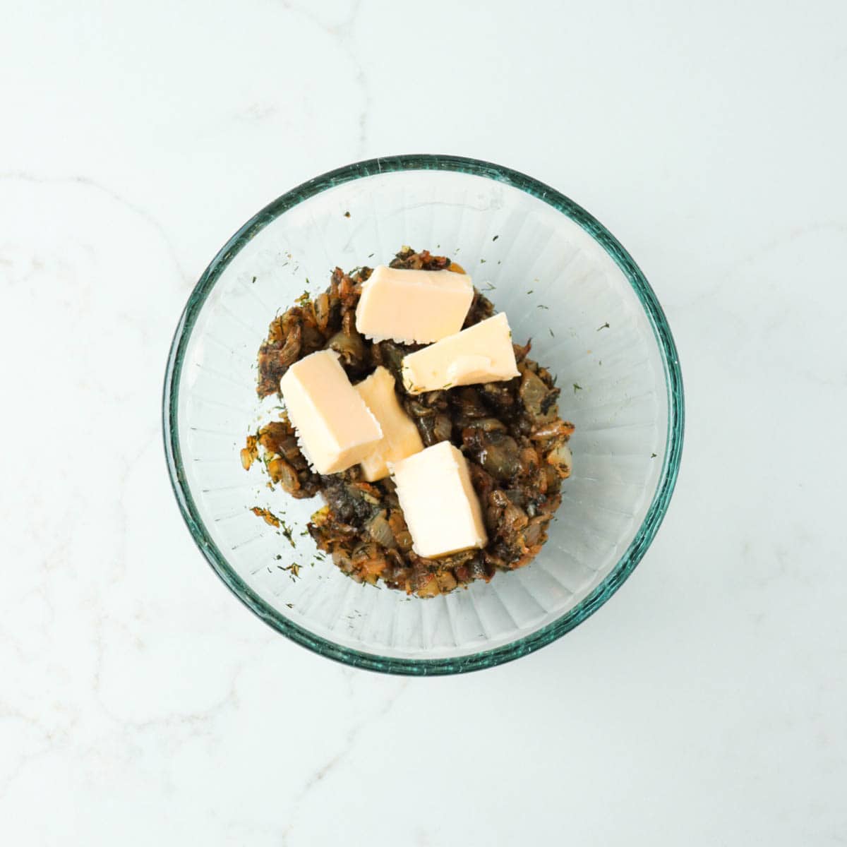 Butter added to caramelized onion and dill mixture.