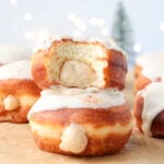 Eggnog custard filled donut stacked on another donut.