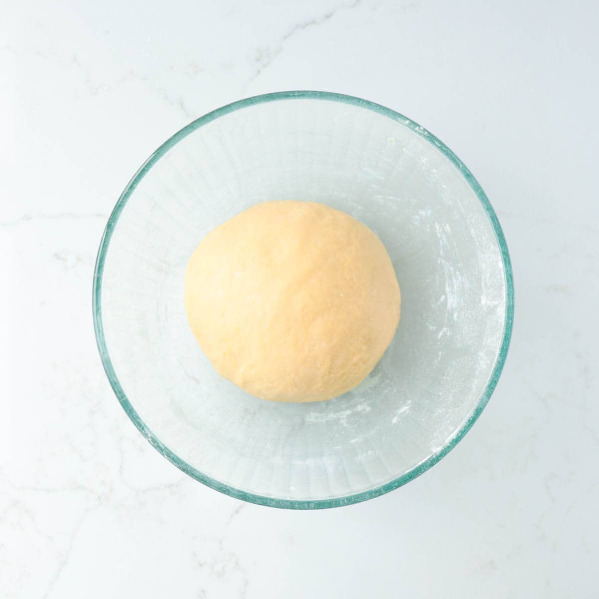 Kneaded dough in a bowl before rising.