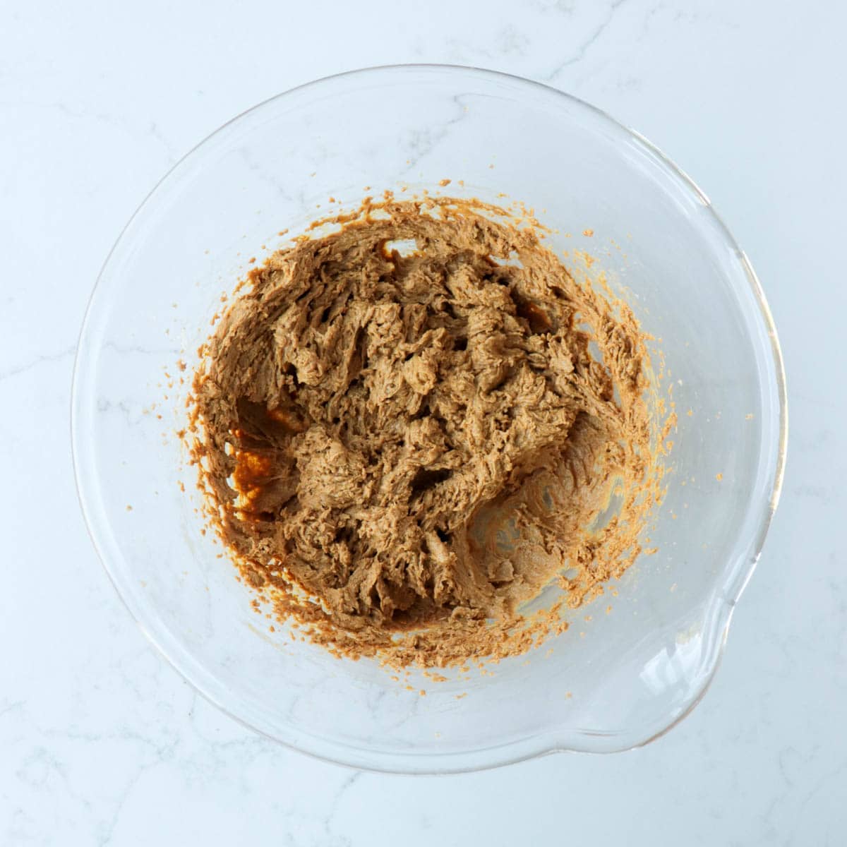 Combined cookie dough in a glass bowl.