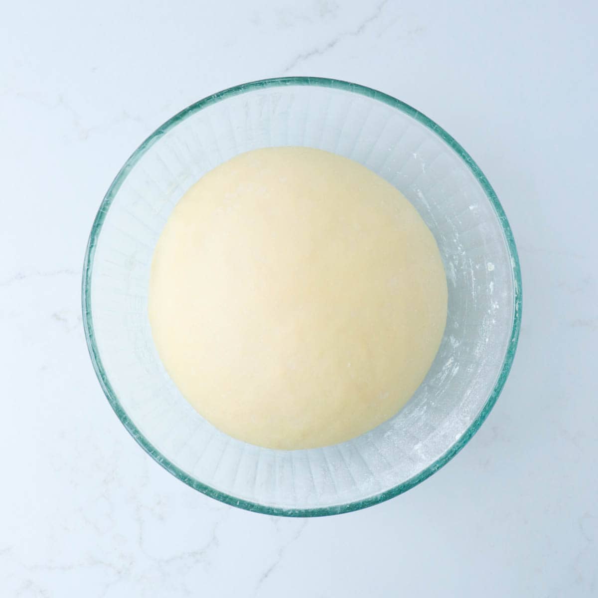 Risen dough in a mixing bowl.