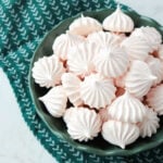 Peppermint meringues in a dark green dish.