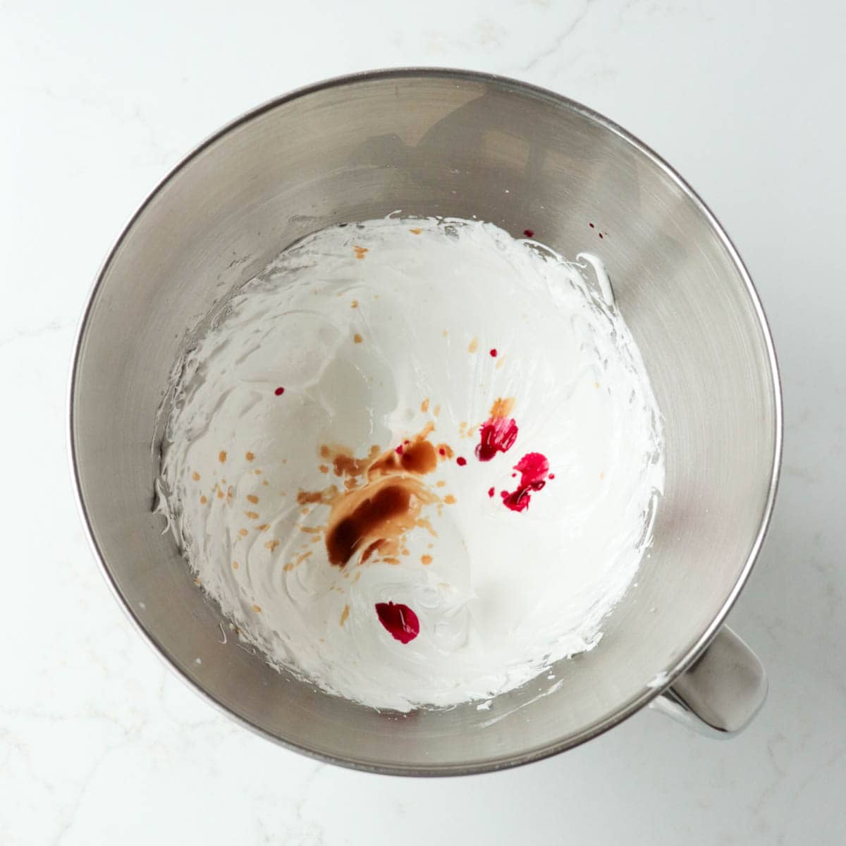 Extracts and food coloring added to meringue.