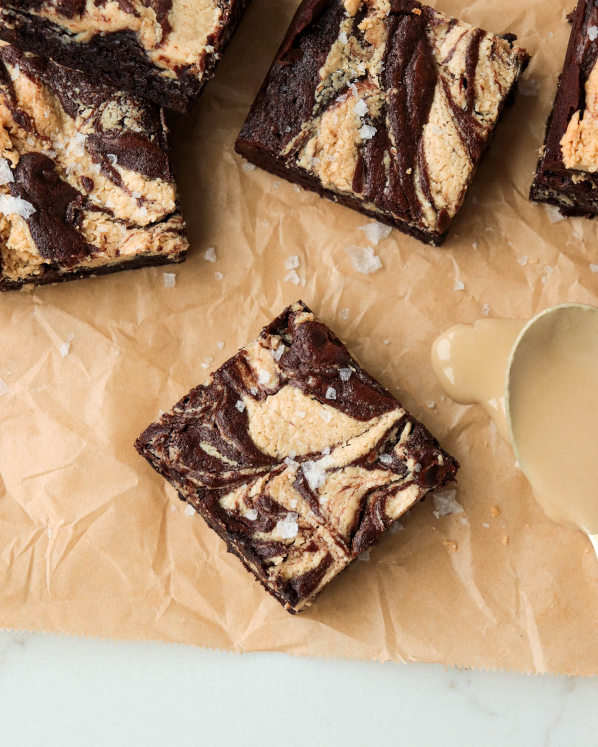 Brownie on a piece of parchment paper.