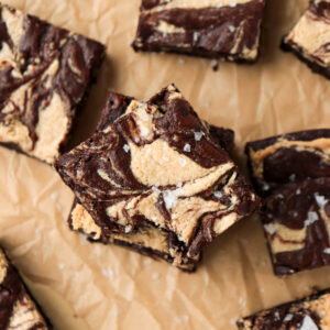 Chocolate brownies with a swirl of tahini on top.