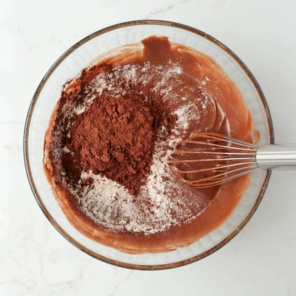 Flour and cocoa powder added to bowl.