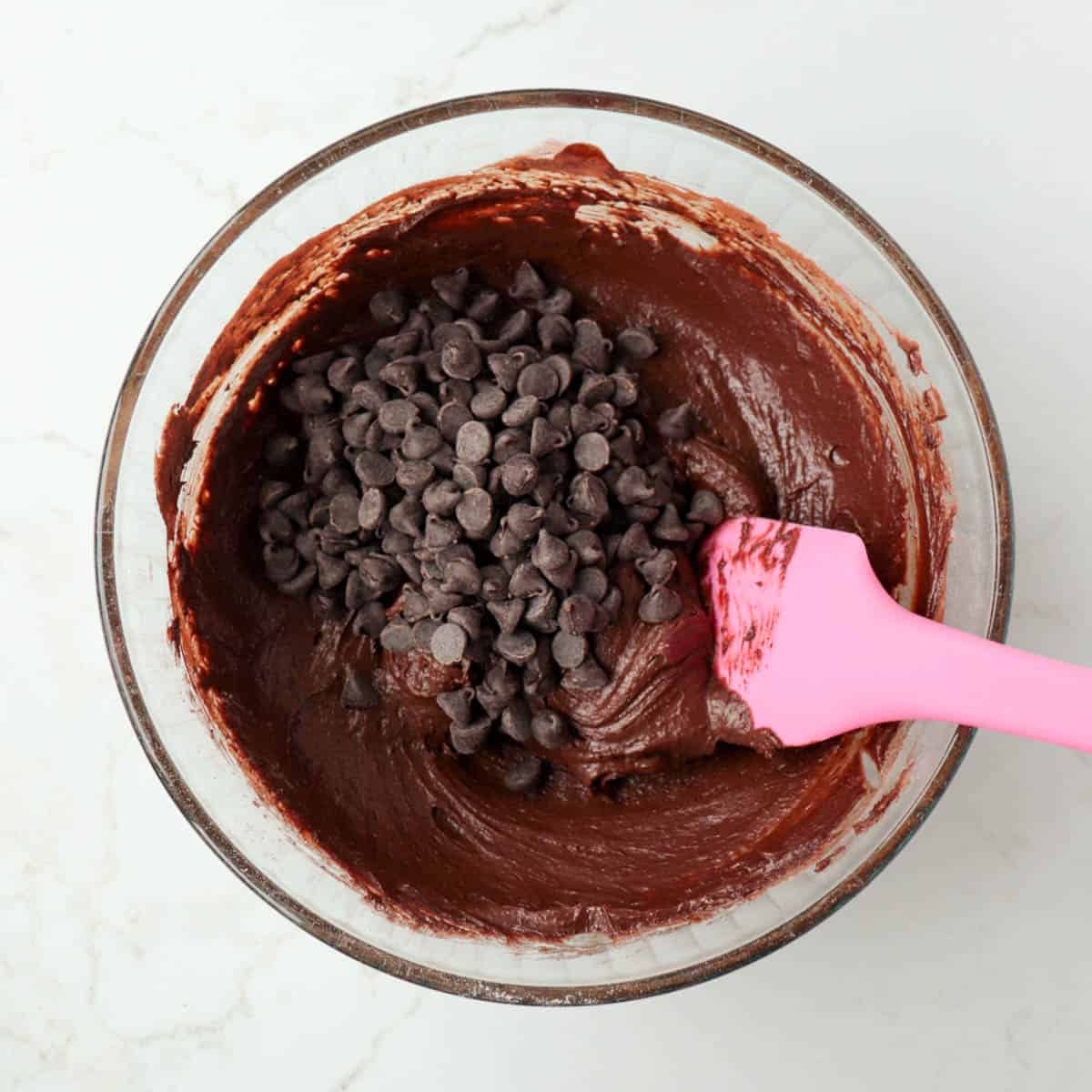 Chocolate chips added to brownie batter.