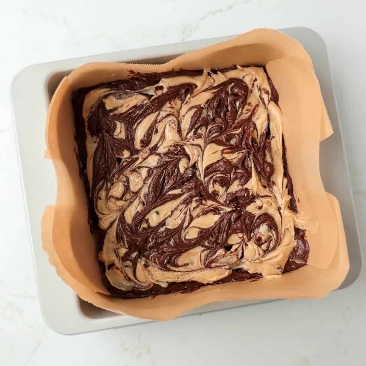 Brownie batter swirled into tahini mixture.