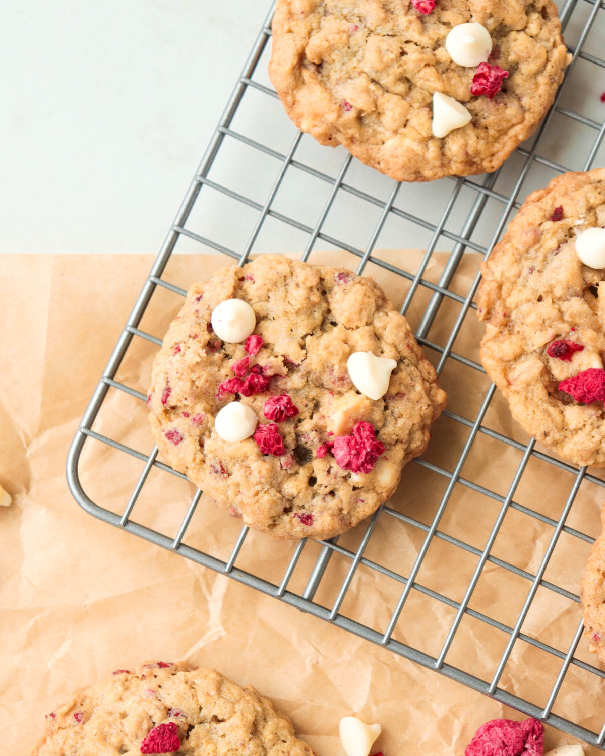 White chocolate berry oatmeal cookies on a wire rack.