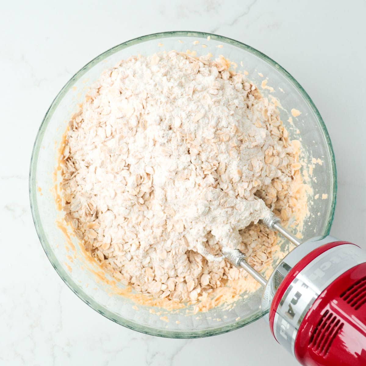 Dry ingredients added to bowl of butter mixture.
