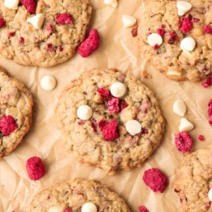 White chocolate berry oatmeal cookies topped with freeze-dried berries and white chocolate chips.