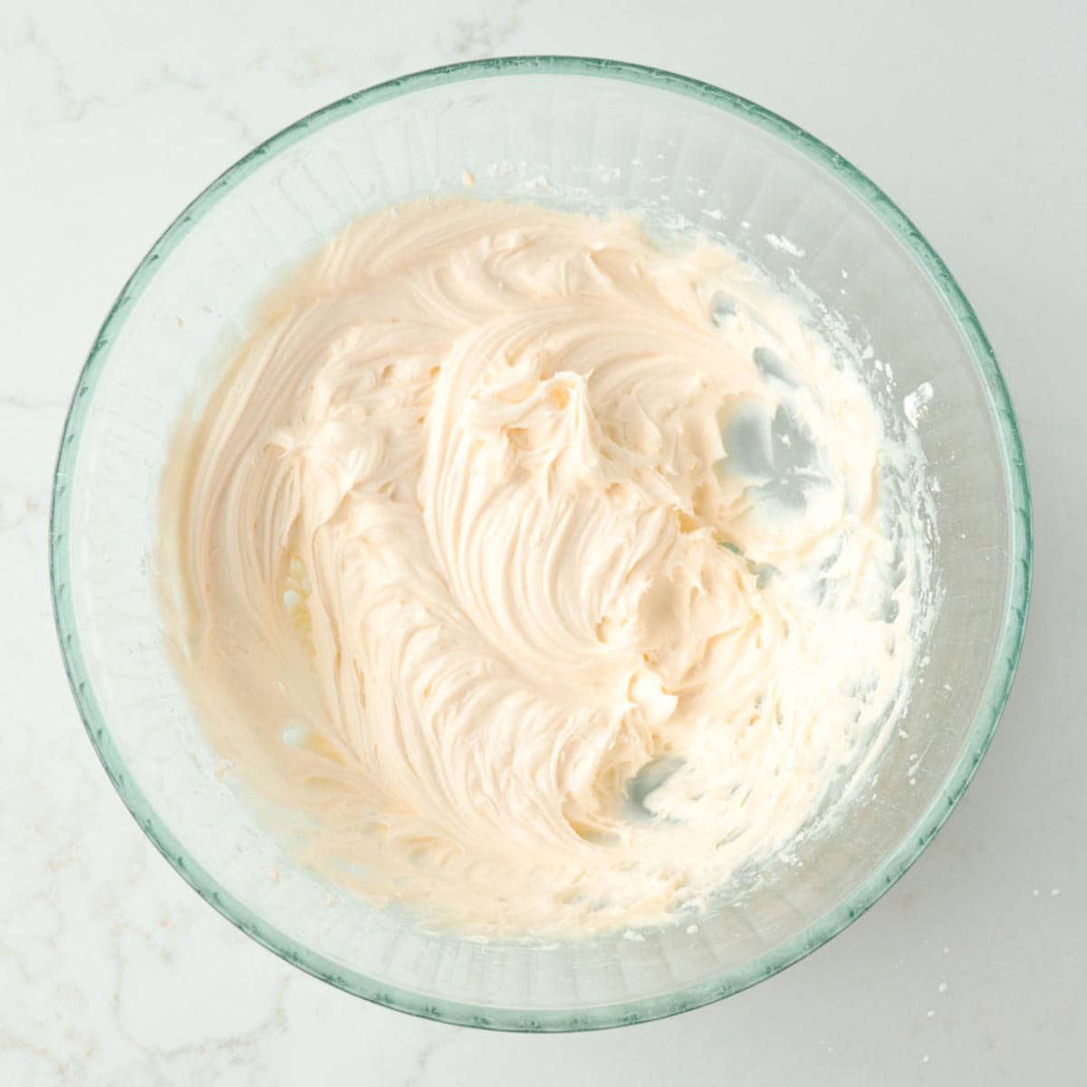 Icing in a glass bowl.
