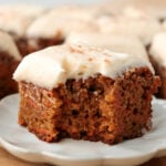 Slice of carrot cake topped with cream cheese frosting.