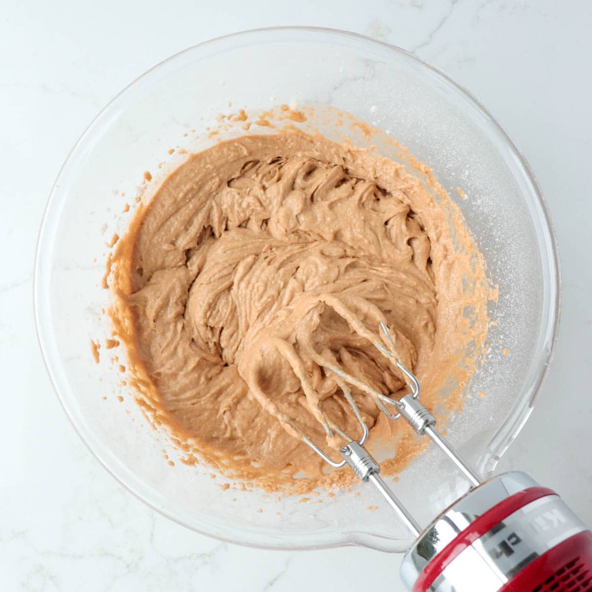 Batter mixed in a mixing bowl with an electric mixer.