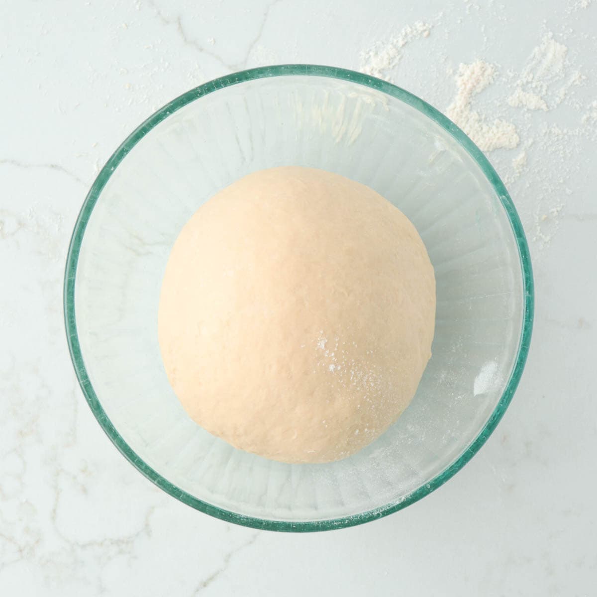 Dough ball in bowl before rising.