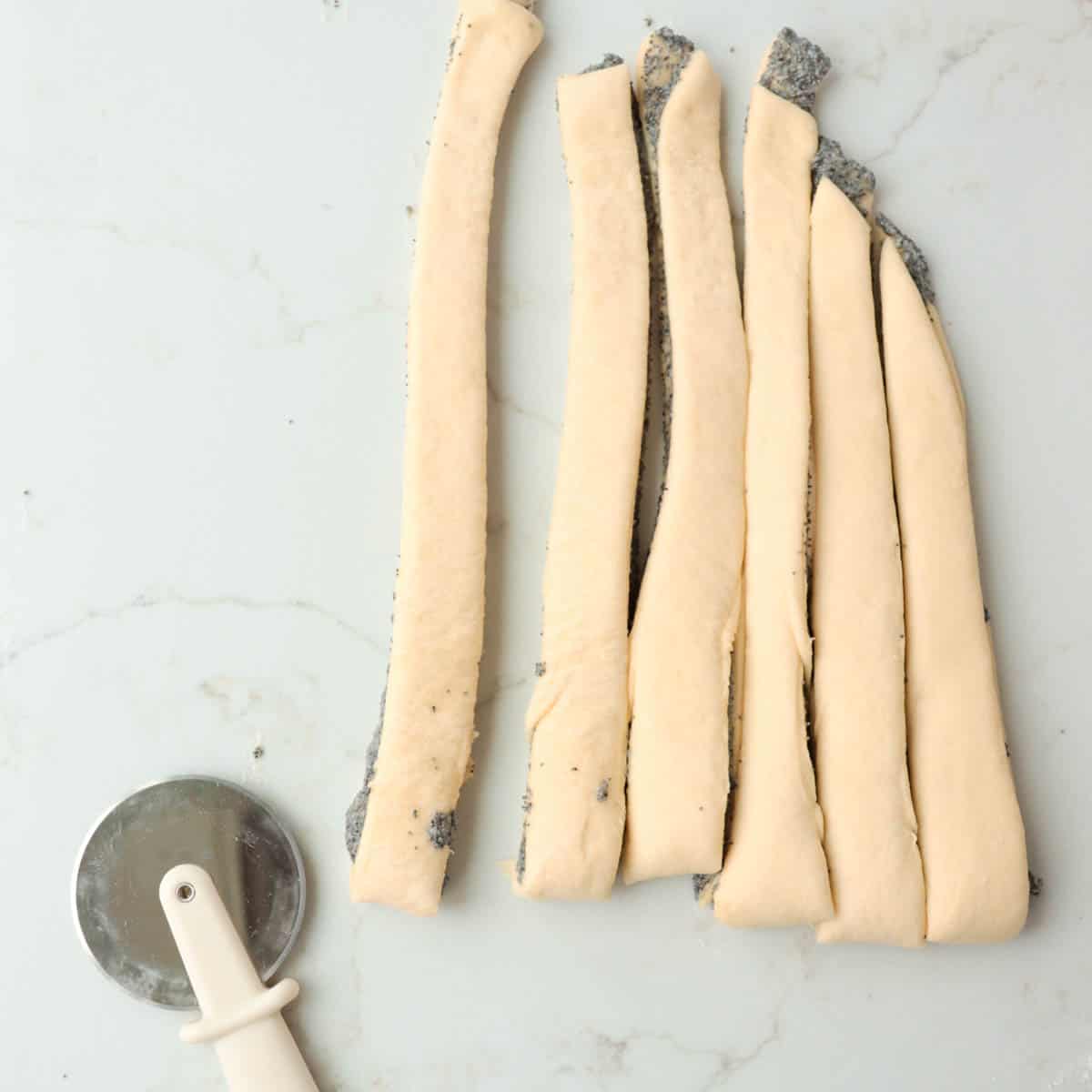 Strips of dough cut with a pizza cutter.