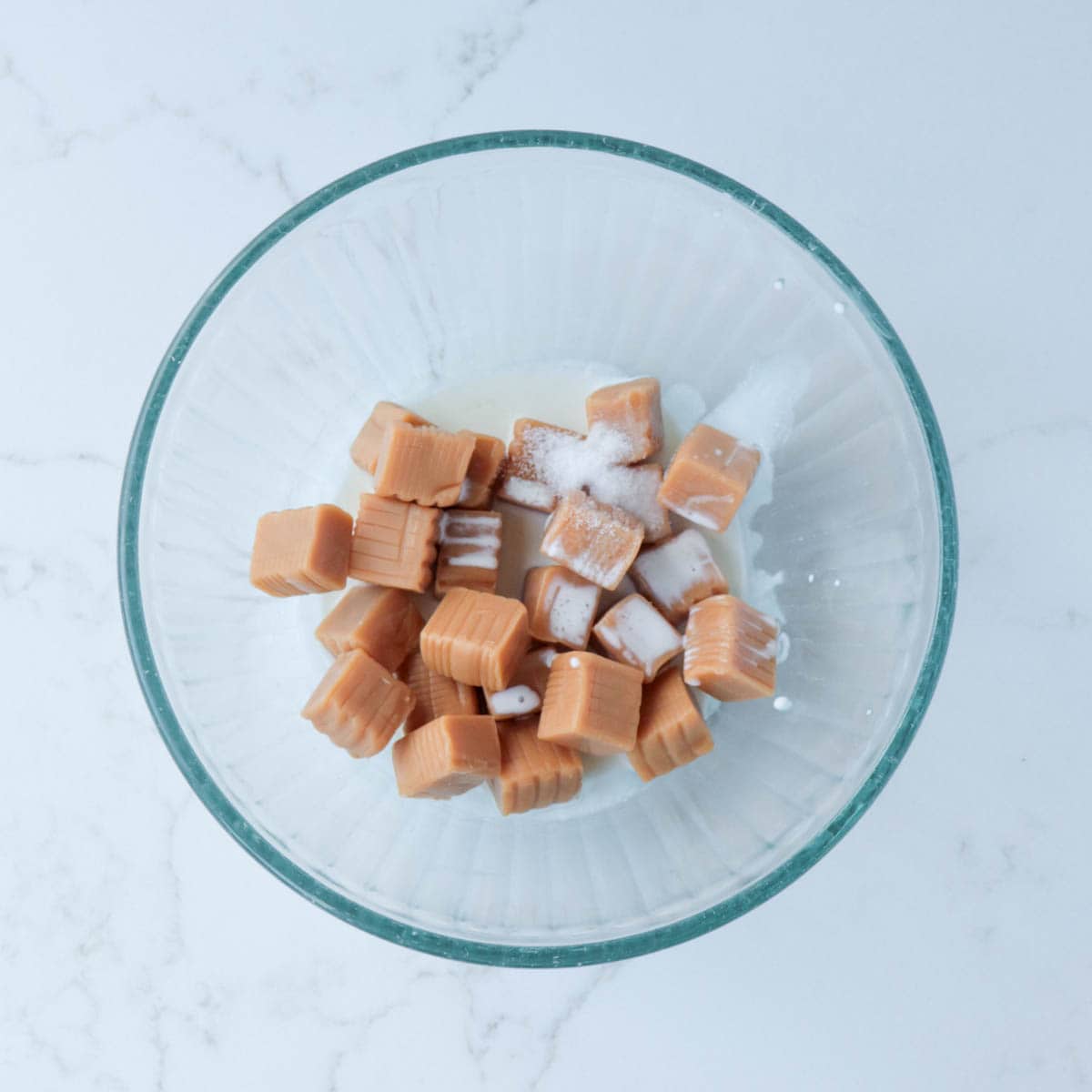 Caramels, cream, and salt in a glass bowl.