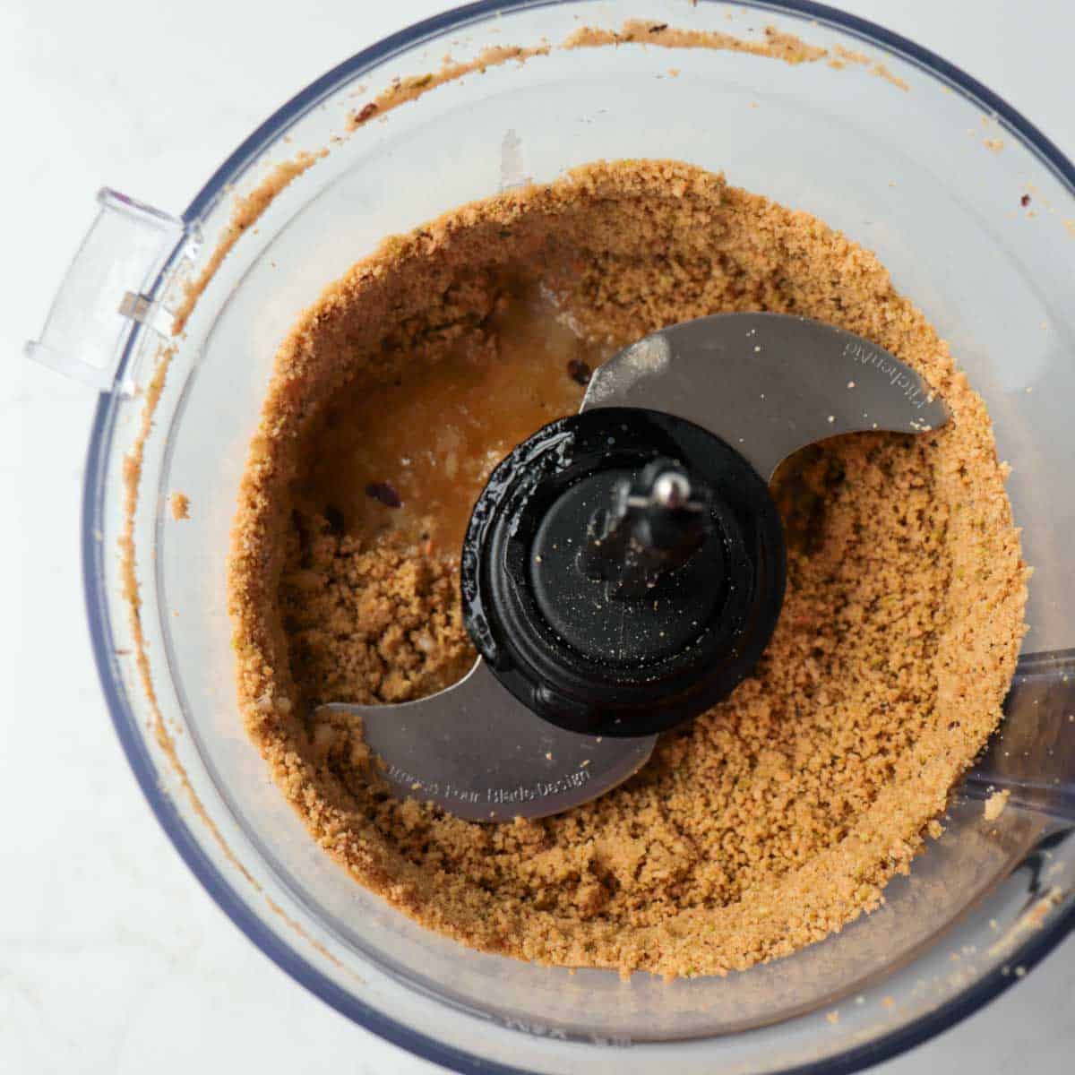 Ground up cookies and pistachios in food processor with melted butter added.