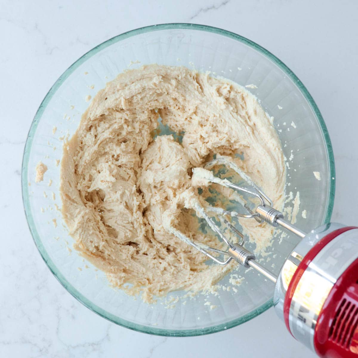 Tahini frosting in a glass mixing bowl.