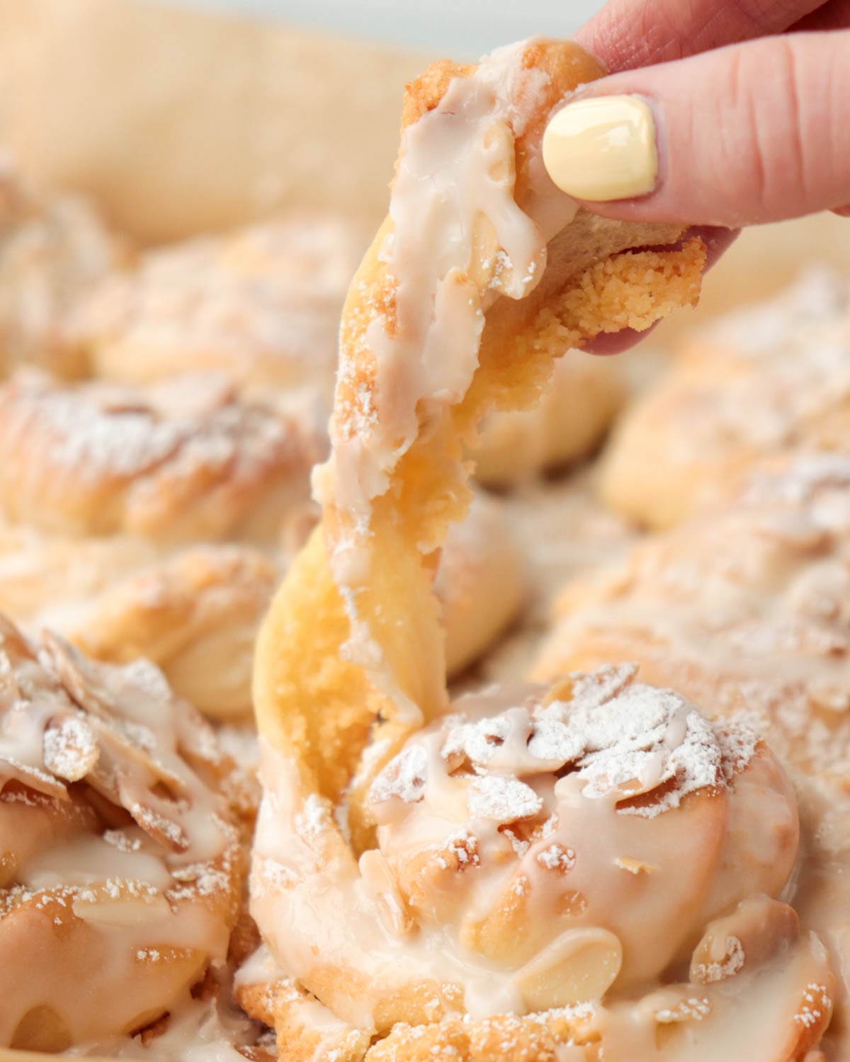 Pulling apart almond bun.