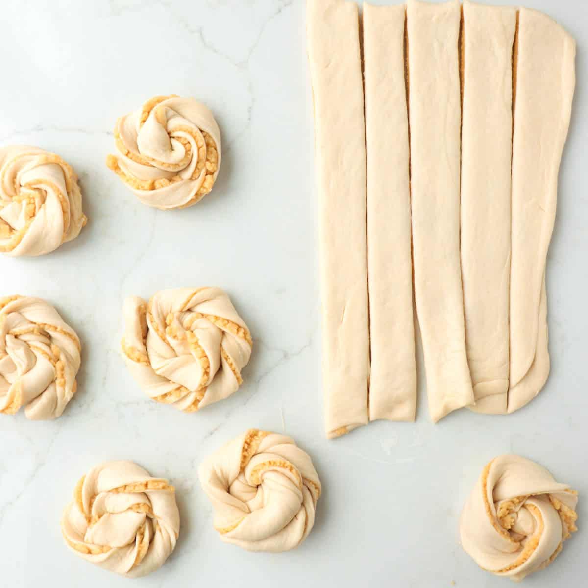 Dough cut into strips and twisted into buns.